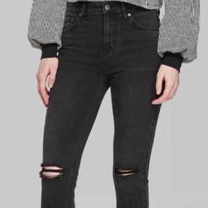 Distressed black skinny jeans